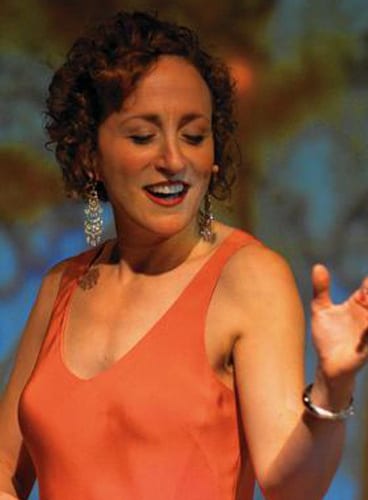 A woman wearing an orange bodysuit