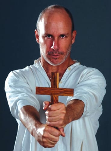 A man holding a wooden cross